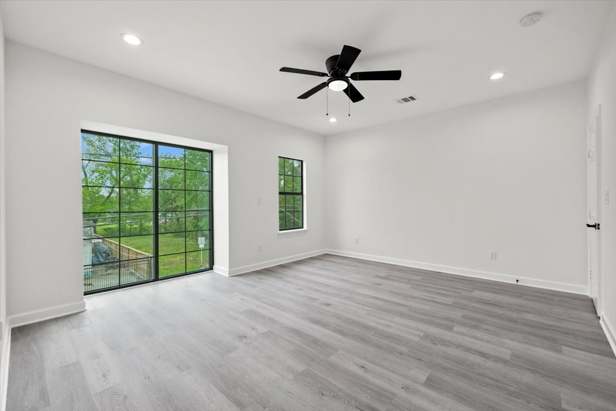 727 East 40th Street Houston, TX 77022 - Photo 13 of 22 a view of an empty room with a window and wooden floor