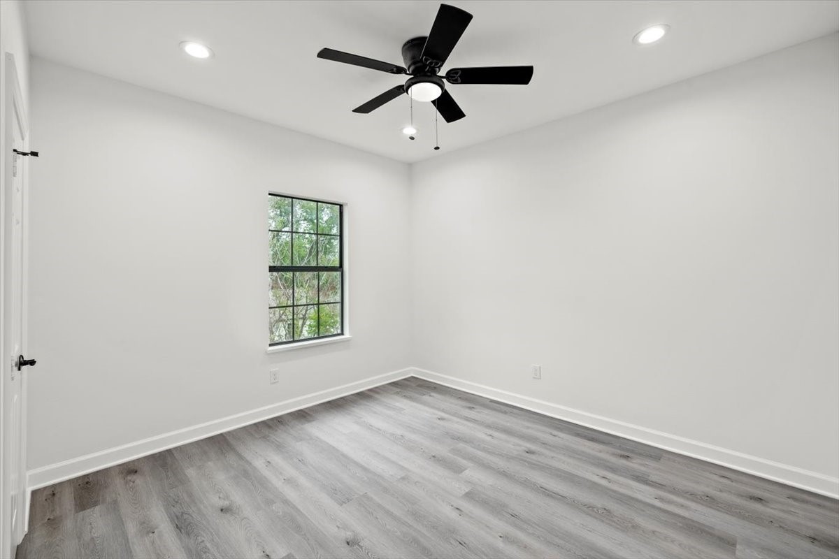 727 East 40th Street Houston, TX 77022 - Photo 18 of 22 an empty room with wooden floor and ceiling fan