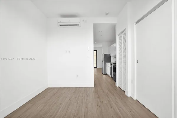 a view of a hallway with wooden floor
