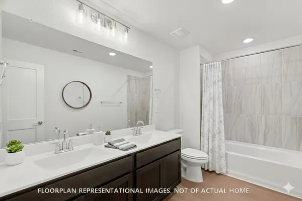 a bathroom with a sink double vanity and a mirror