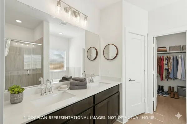 a bedroom with a bed windows and a rug