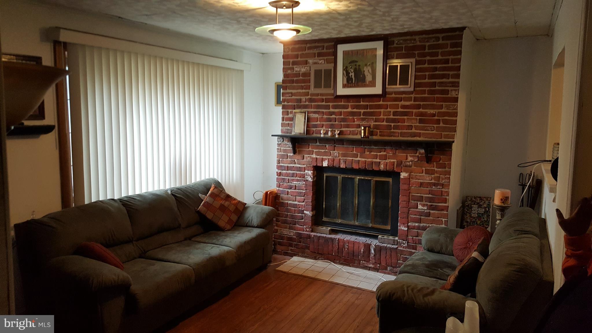 9002 Ardmore Road Springdale, MD 20706 - Photo 6 of 21 Living Room- Brick Wood Fireplace