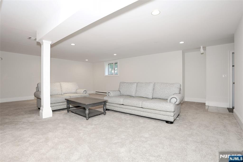 65 Ross Avenue Demarest, NJ 07627 - Photo 39 of 48 a living room with furniture and a rug