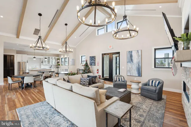 a living room with furniture a flat screen tv and a large window