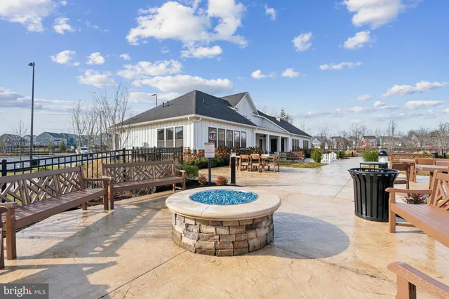 a view of a patio with dining table and chairs