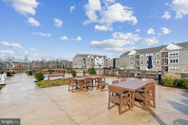 a view of two chairs and tables in the patio
