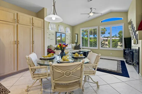 a dining room with furniture a chandelier and wooden floor