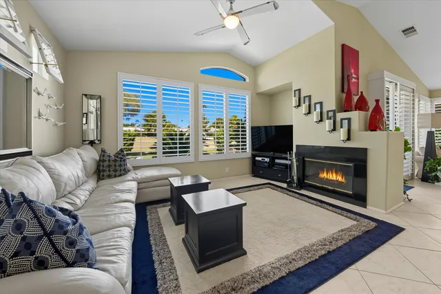 a living room with furniture fireplace and flat screen tv