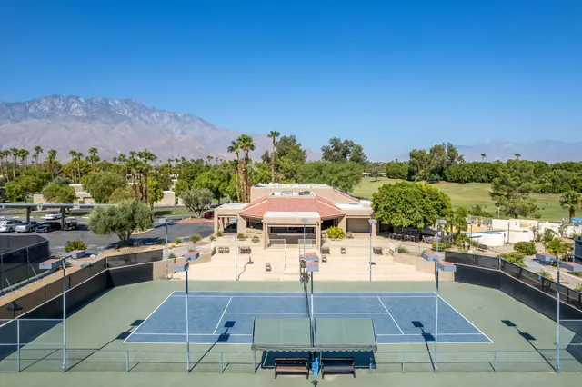 a view of a patio with chairs and a table