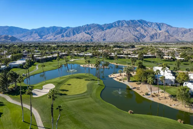 a view of a city with swimming pool and mountains