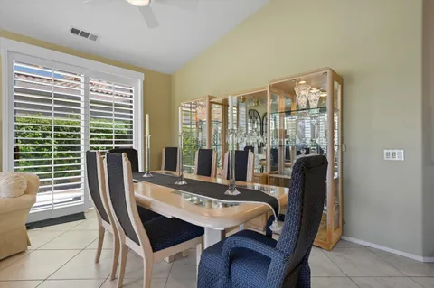 a kitchen with granite countertop a refrigerator a stove a microwave and cabinets