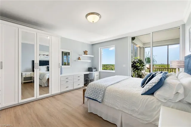 a bedroom with a large bed and potted plant