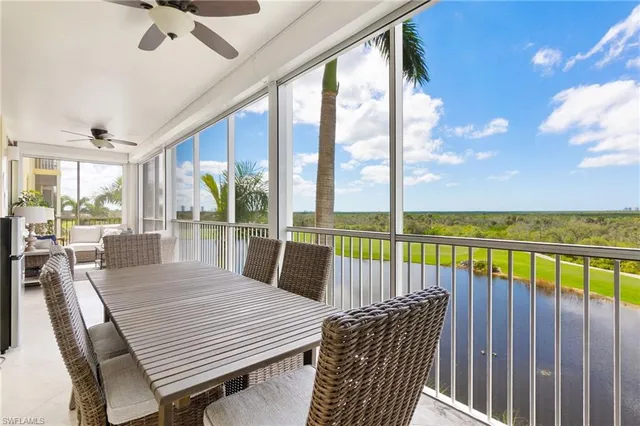 a dining room with furniture and a floor to ceiling window