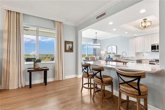 a room with stainless steel appliances a table and chairs in it
