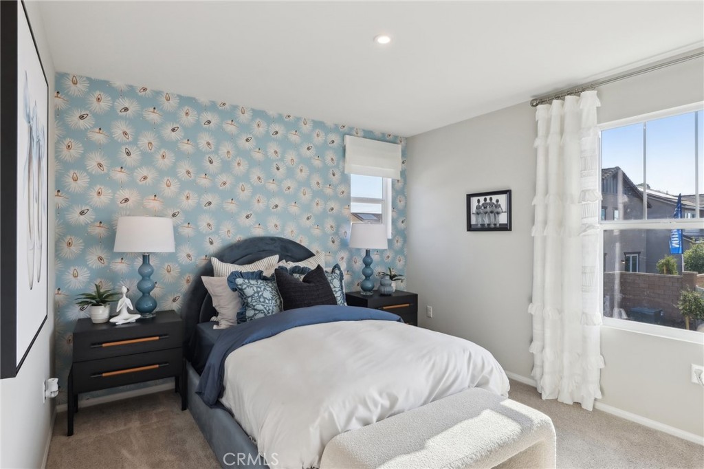 15535 April Dawn Way, Unit 1 Fontana, CA 92336 - Photo 12 of 16 a bedroom with a bed and a mirror