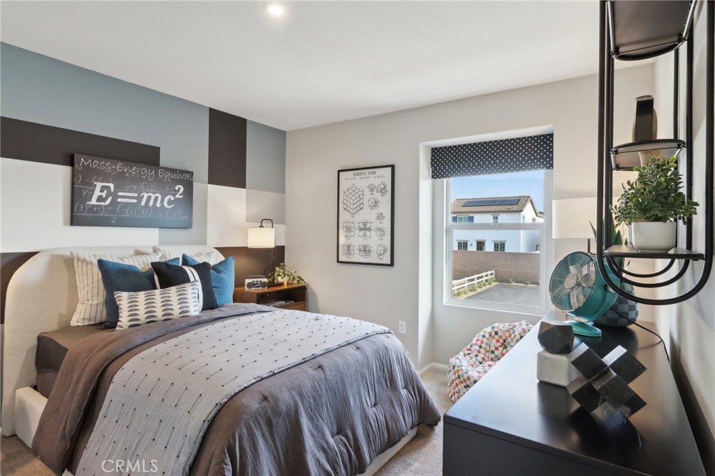 15535 April Dawn Way, Unit 1 Fontana, CA 92336 - Photo 13 of 16 a bedroom with a bed and glass table