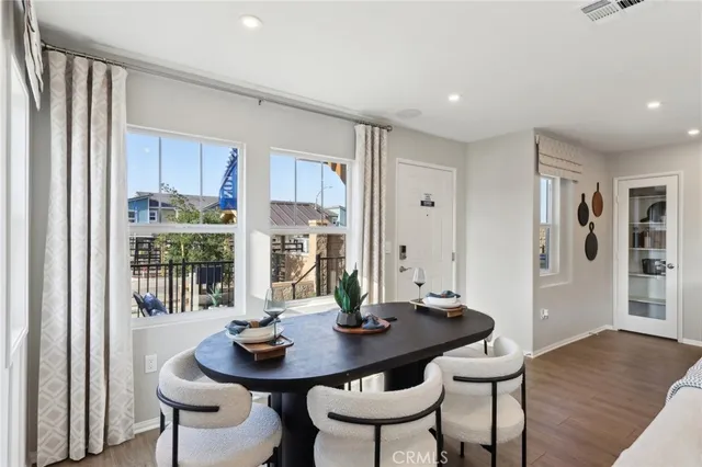a view of a dining room with furniture window and wooden floor