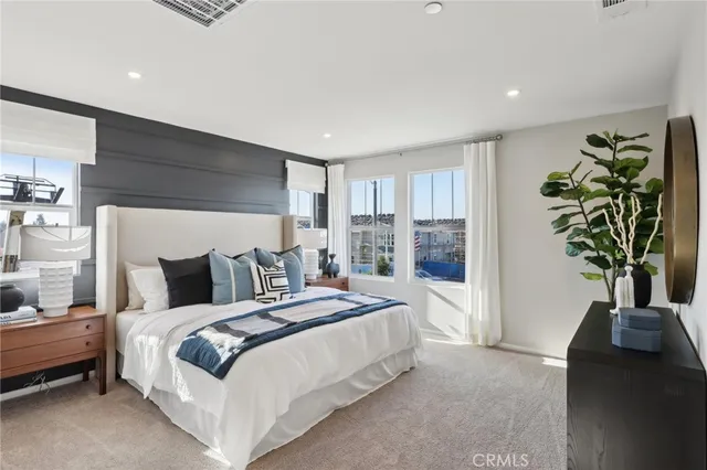 a bedroom with a bed and a potted plant