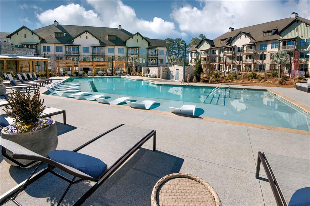 1545 Whitemarsh Road, Unit A2 Kennesaw, GA 30152 - Photo 2 of 46 a view of a patio with swimming pool table and chairs