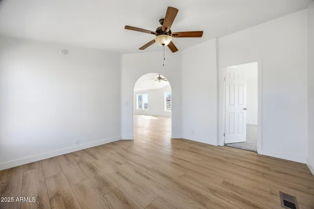 a view of an empty room and wooden floor