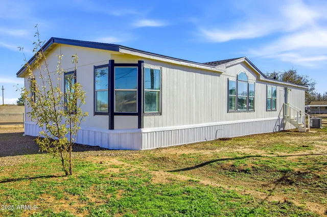a view of a house with wooden fence