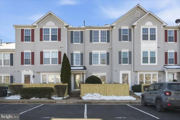 a front view of a residential apartment building with a yard