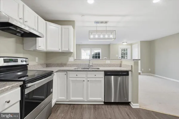a kitchen with stainless steel appliances granite countertop a sink and cabinets