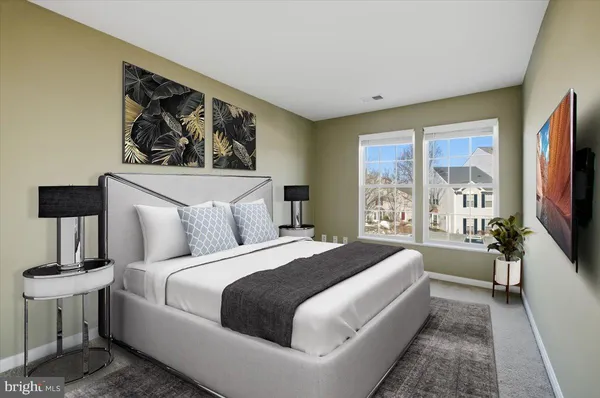a spacious bedroom with a large bed a flat screen tv and a window