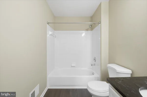 a bathroom with a toilet and a bathtub