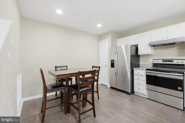 a view of a dining room with furniture and wooden floor