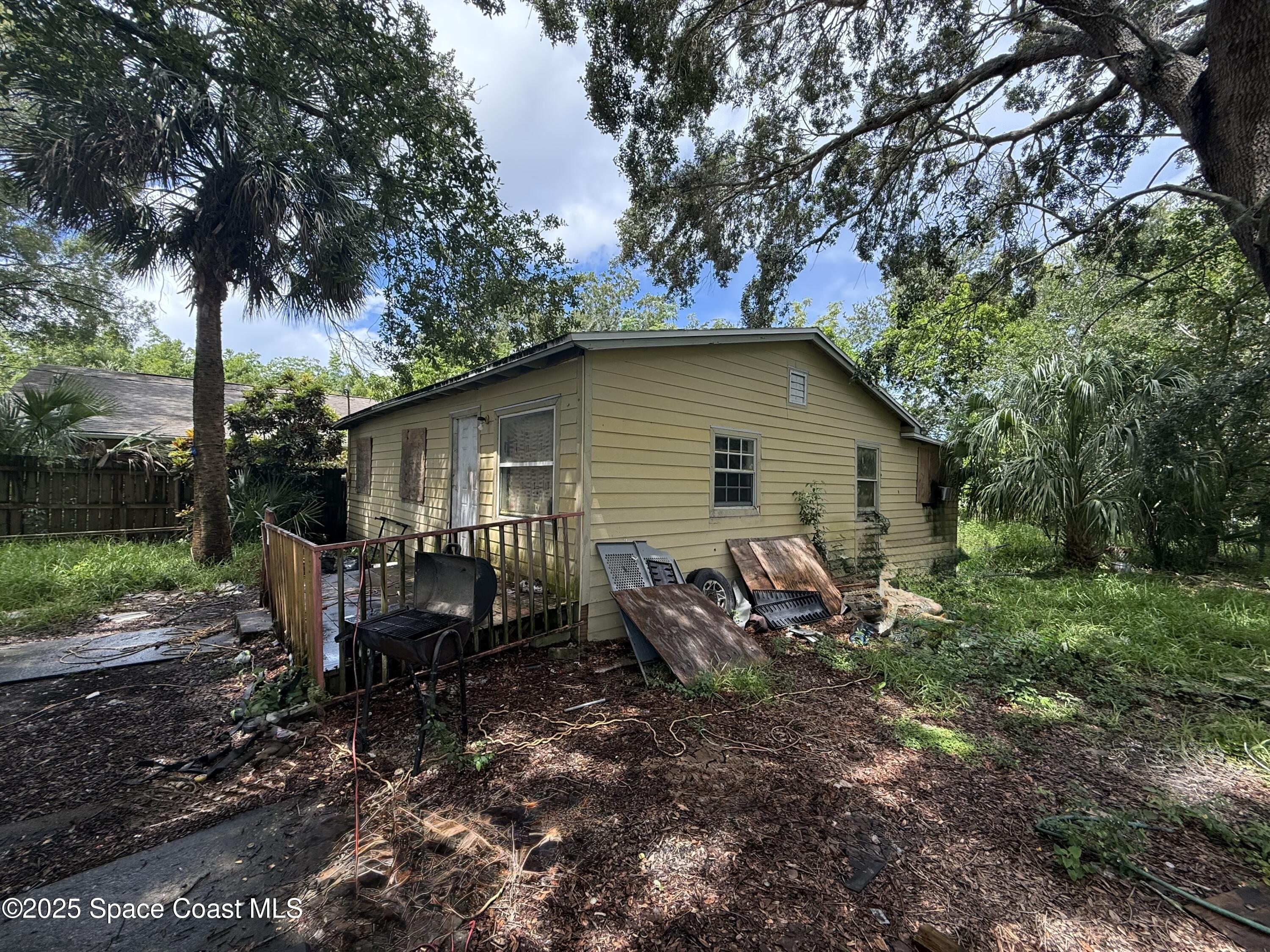 580 Easy Street Merritt Island, FL 32953 - Photo 5 of 7 a view of a house with backyard and a tree