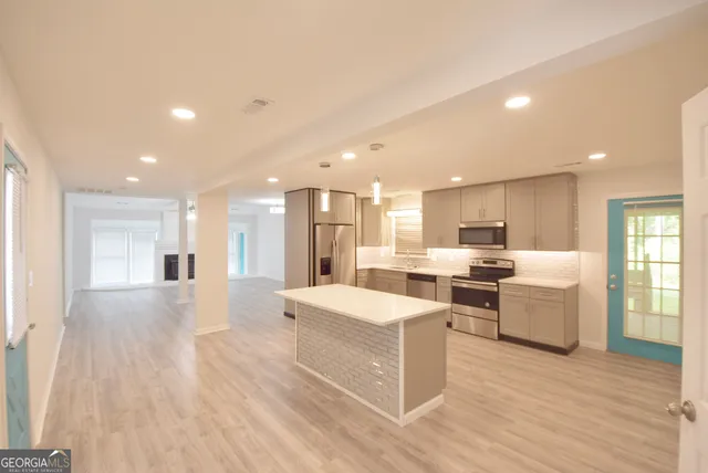 an empty room with windows and entrance