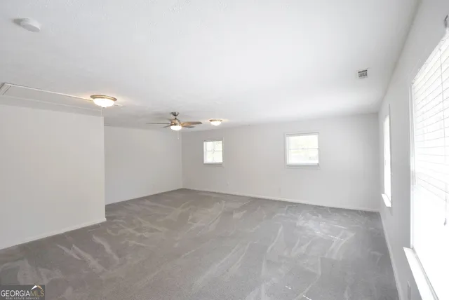 a view of empty room with windows