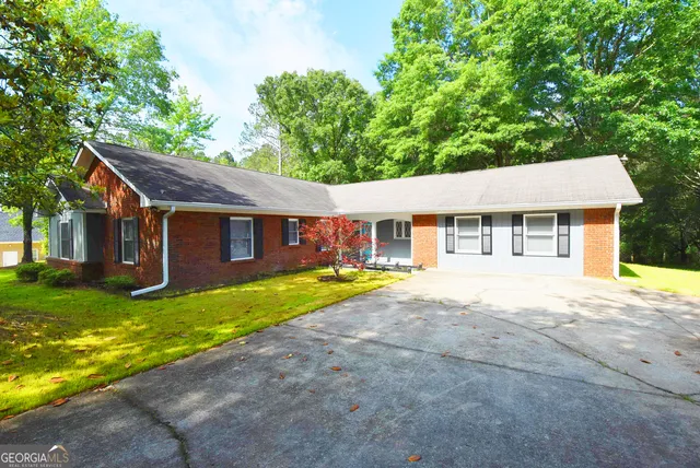 a view of swimming pool with trees and yard