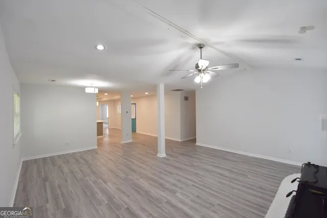 a view of a hallway with wooden floor