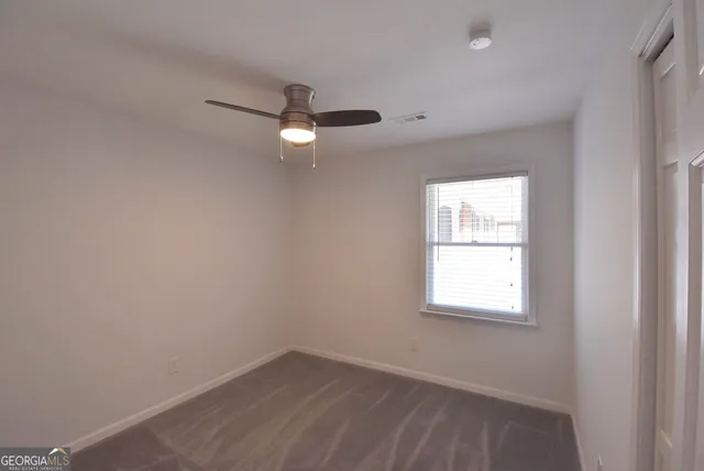 a spacious bathroom with a shower sink and mirror