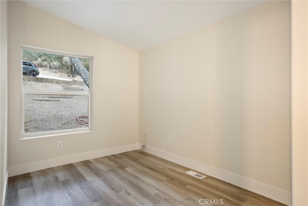 3550 Ardana Road Paso Robles, CA 93446 - Photo 13 of 23 a view of an empty room with wooden floor and a window