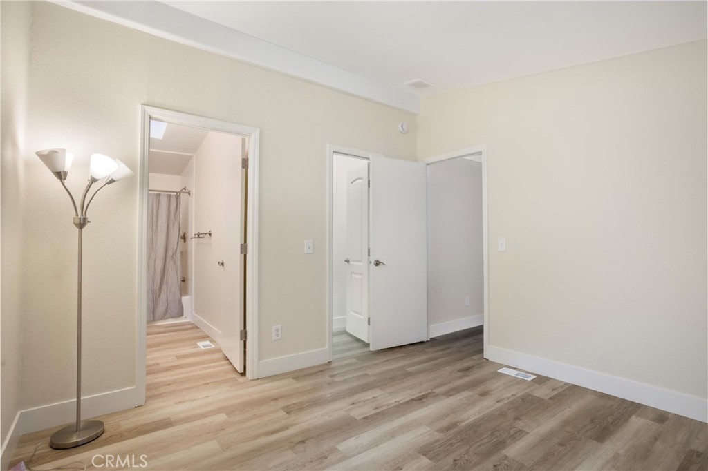 3550 Ardana Road Paso Robles, CA 93446 - Photo 18 of 23 a view of a hallway with wooden floor and a bathroom