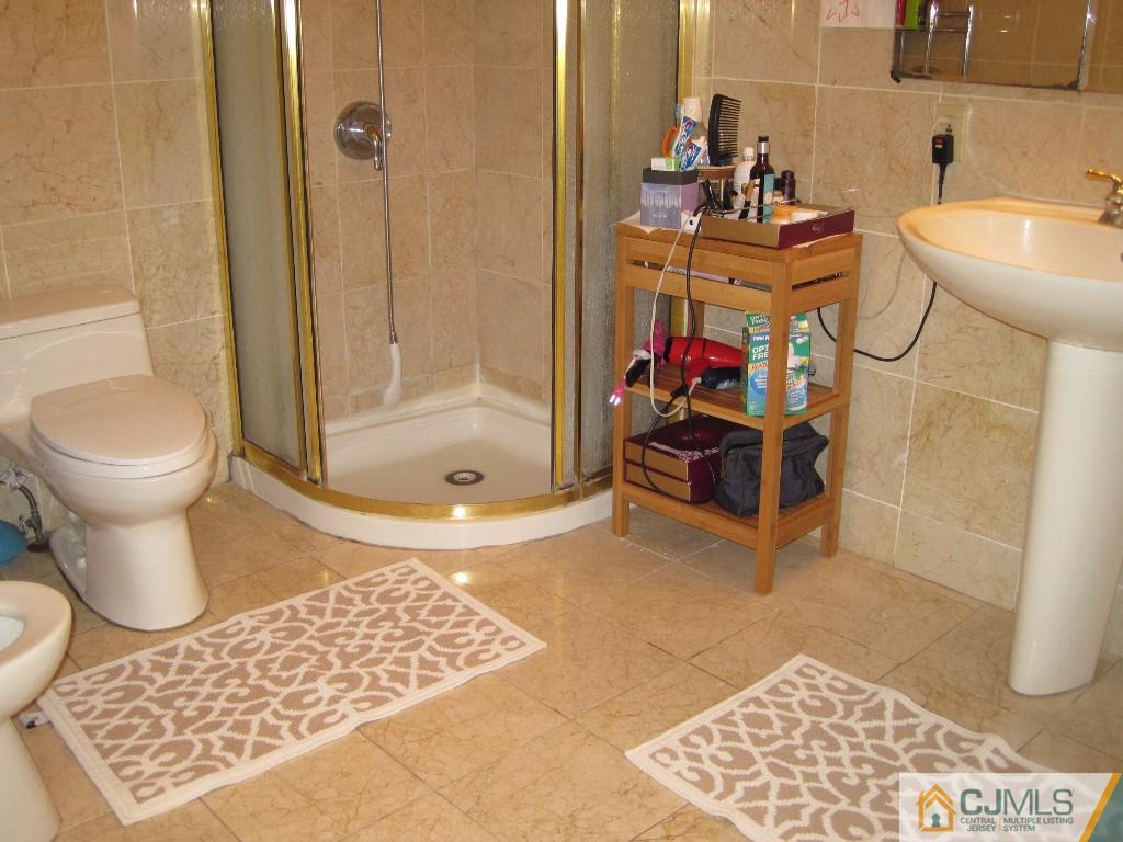 26 Richard Road Edison, NJ 08820 - Photo 11 of 18 a bathroom with a sink toilet and shower
