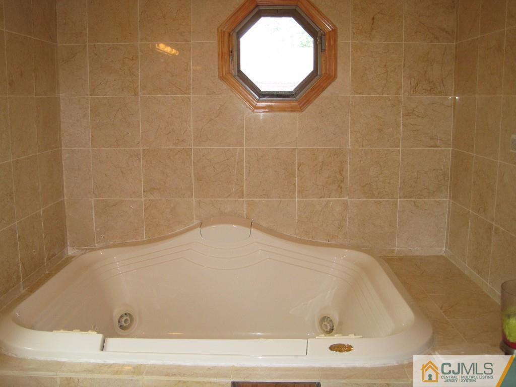 26 Richard Road Edison, NJ 08820 - Photo 12 of 18 a bathroom with a tub