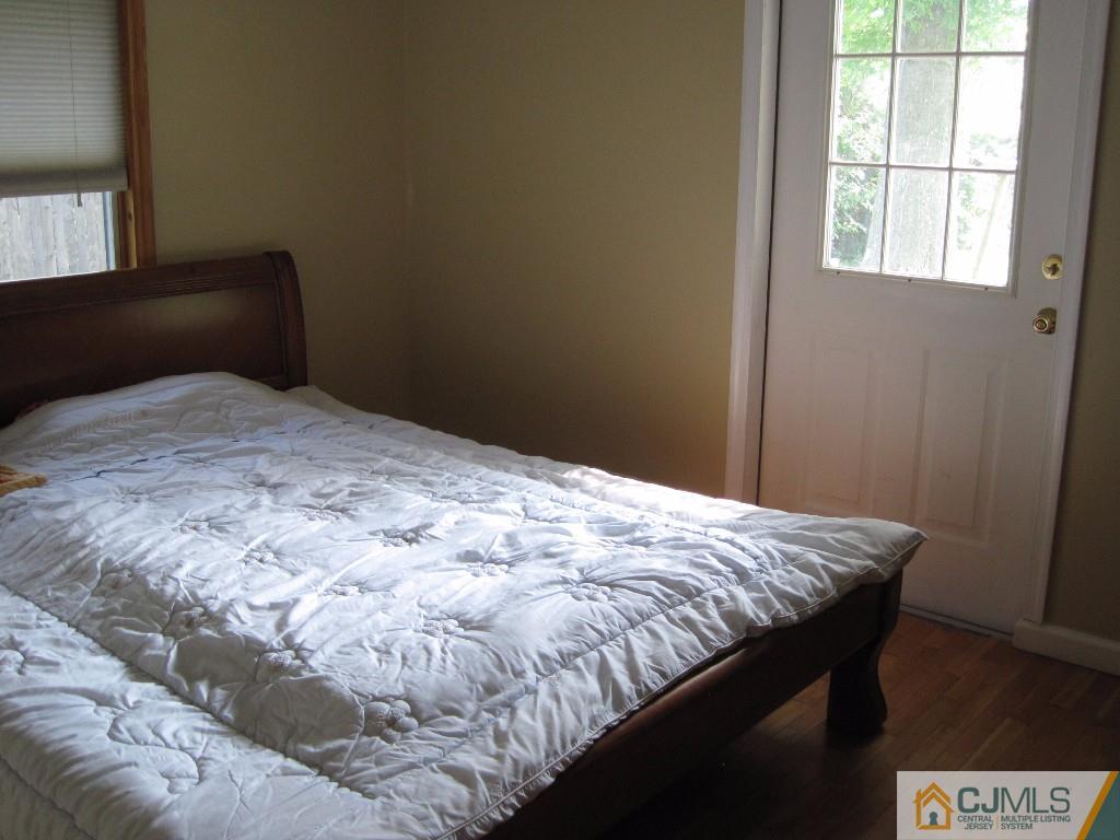 26 Richard Road Edison, NJ 08820 - Photo 14 of 18 a bed sitting in a bedroom next to a window