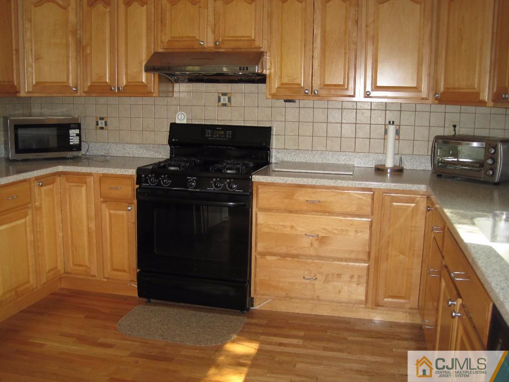 26 Richard Road Edison, NJ 08820 - Photo 5 of 18 a kitchen with stainless steel appliances granite countertop a stove and a refrigerator