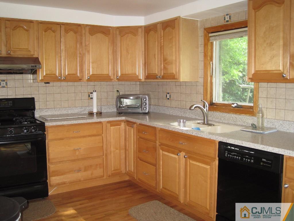 26 Richard Road Edison, NJ 08820 - Photo 6 of 18 a kitchen with stainless steel appliances granite countertop a sink stove and refrigerator