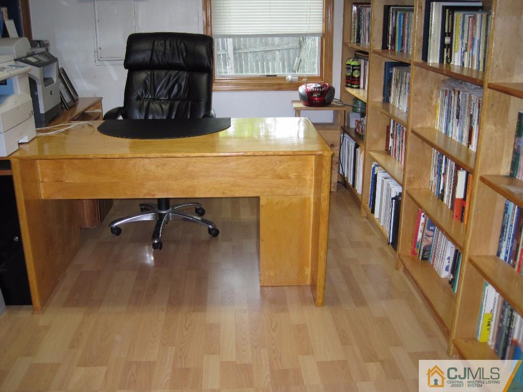26 Richard Road Edison, NJ 08820 - Photo 10 of 18 a room with a table chairs and a book shelf