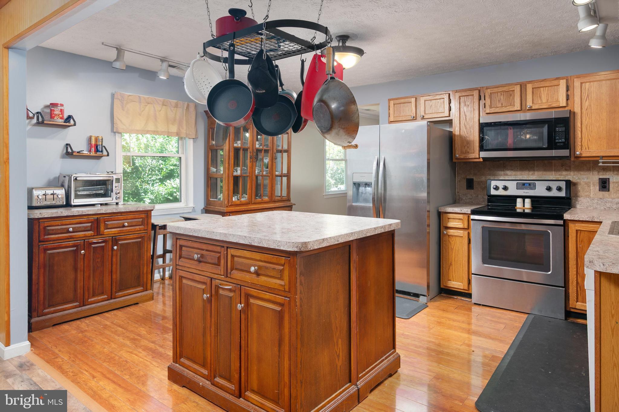 1839 Harbor Drive Chester, MD 21619 - Photo 4 of 23 a kitchen with stainless steel appliances granite countertop a sink and dishwasher a stove top oven with wooden floor