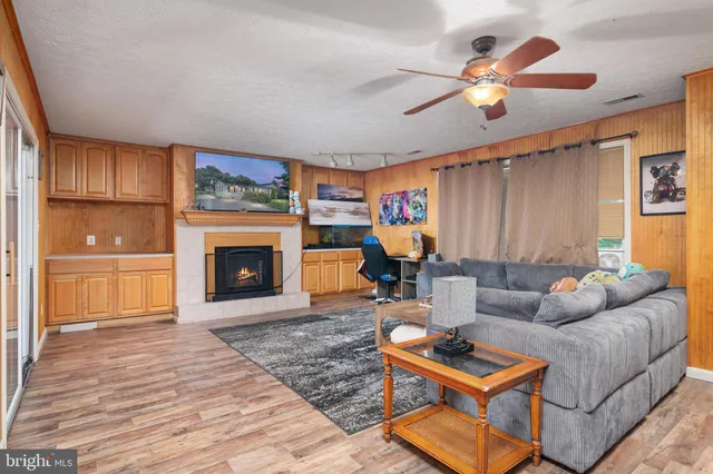 a living room with furniture a fireplace and a flat screen tv