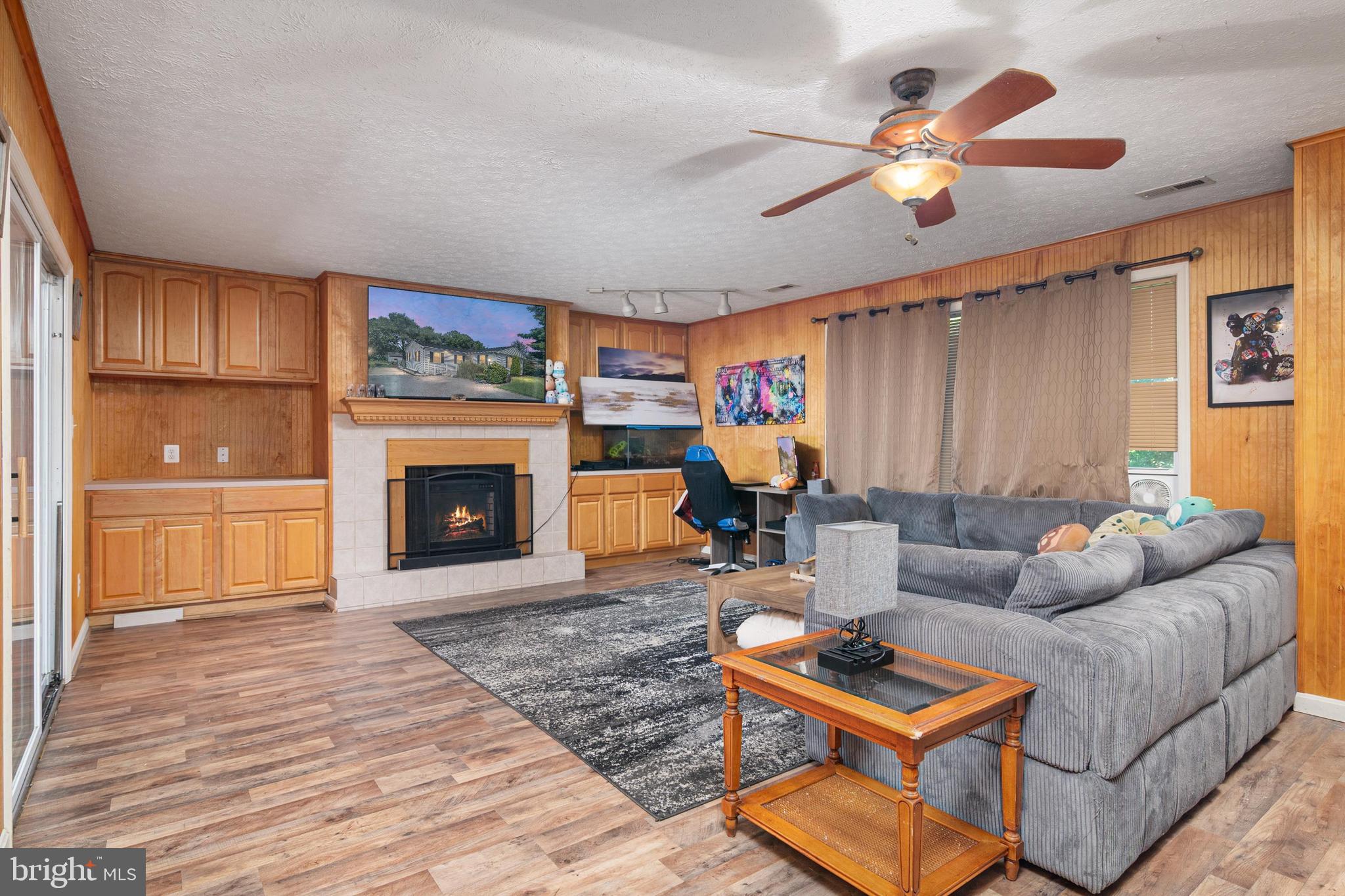 1839 Harbor Drive Chester, MD 21619 - Photo 8 of 23 a living room with furniture a fireplace and a flat screen tv