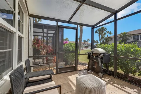 a room with furniture and a floor to ceiling window