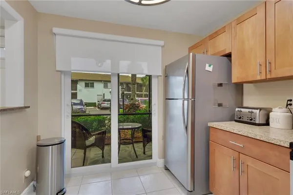 a kitchen with stainless steel appliances granite countertop a refrigerator and a sink