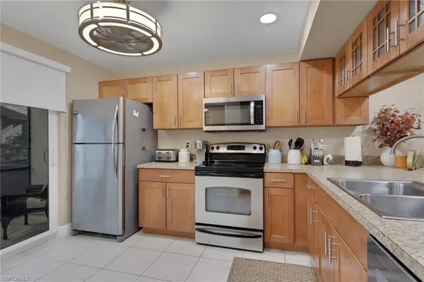 a kitchen with stainless steel appliances granite countertop a stove microwave and cabinets